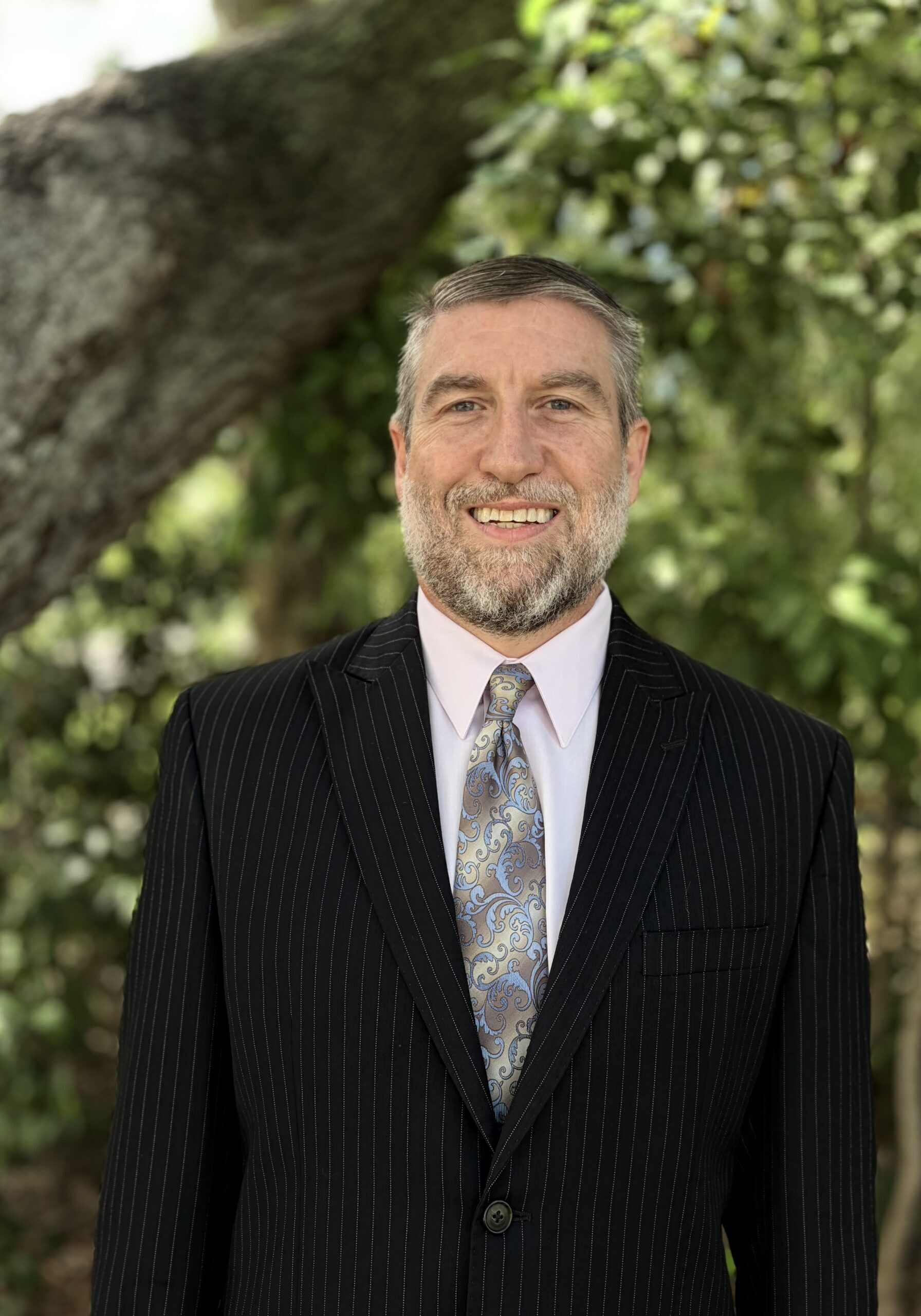 Smiling man in suit outdoors